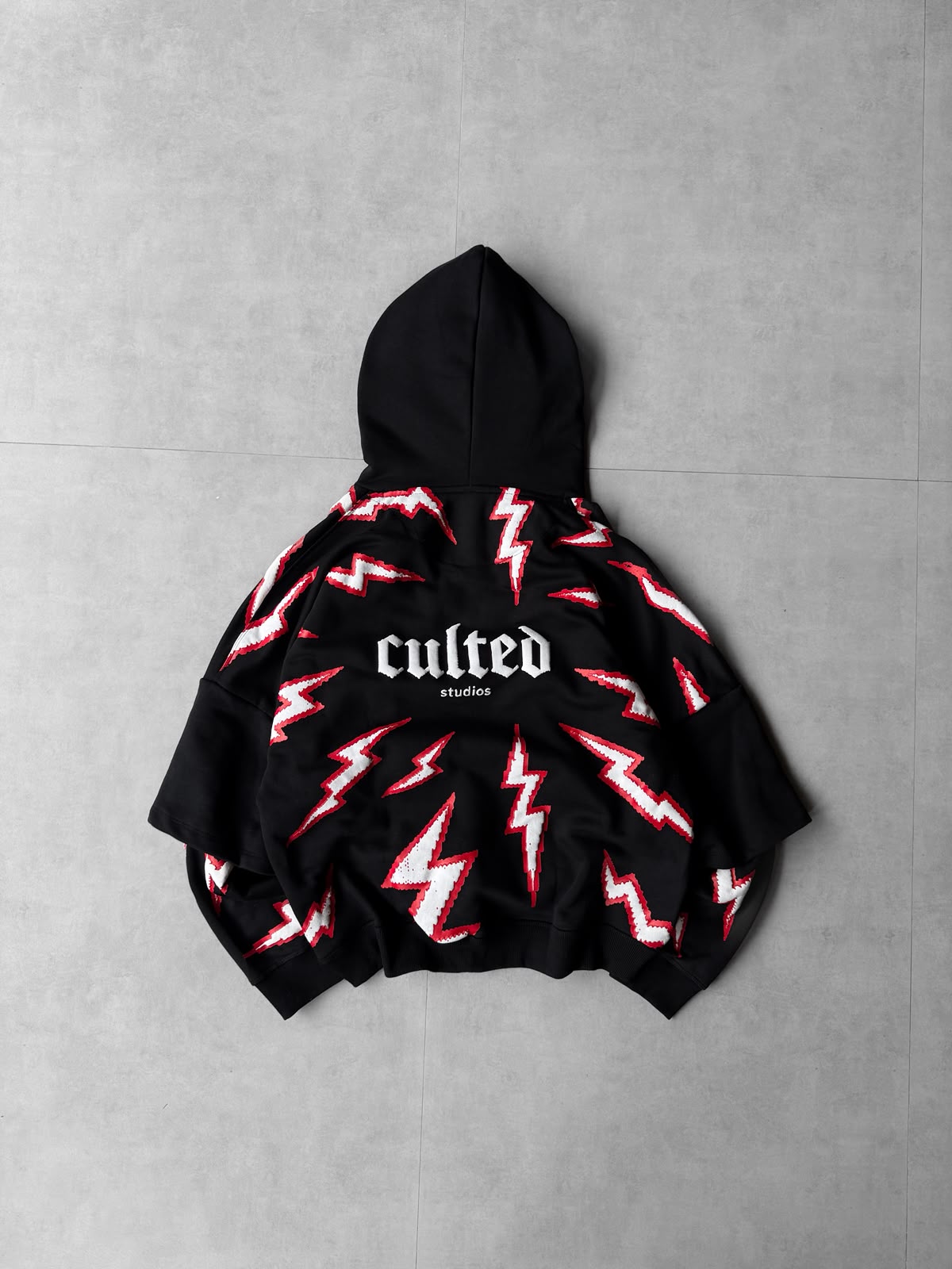Black lightning puff-print oversized hoodie — front